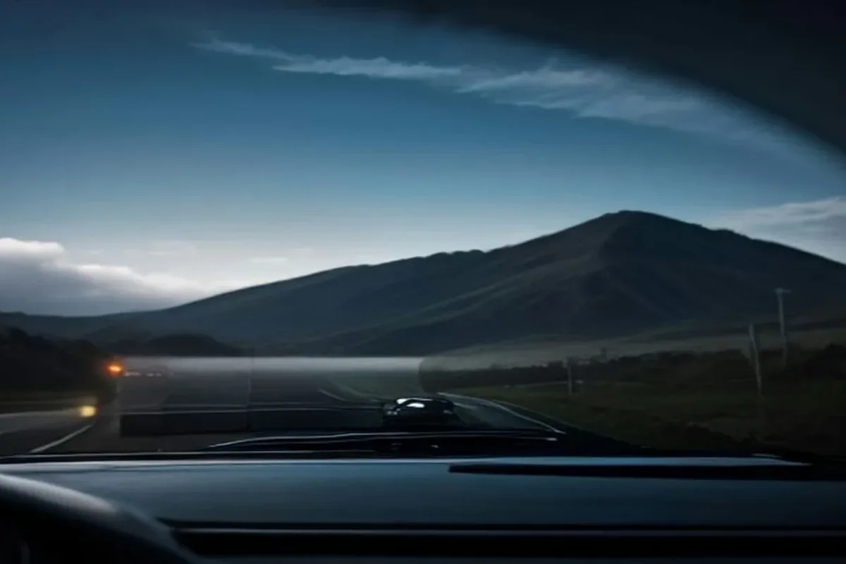 Car driving on a highway with driver-assistance technology