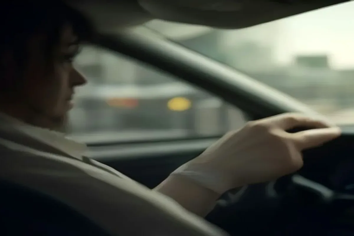 Driver behind the wheel in city traffic