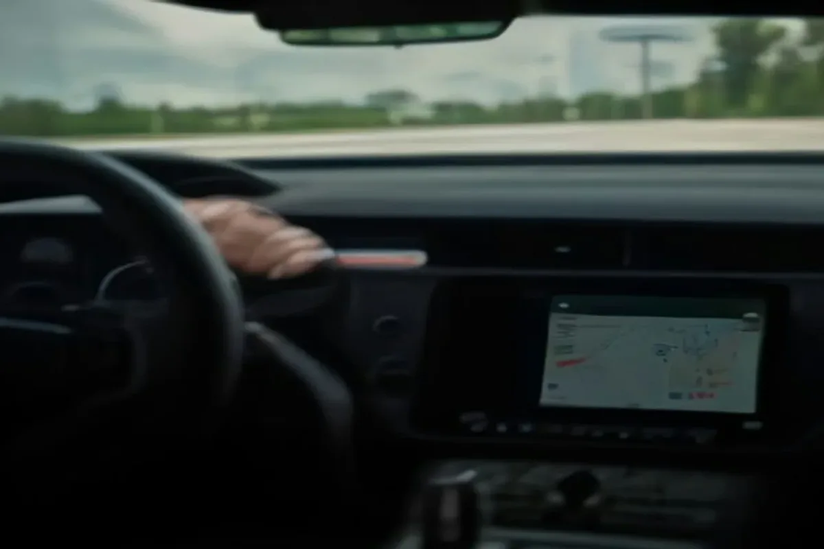 Car dashboard with a large touchscreen beside the steering wheel