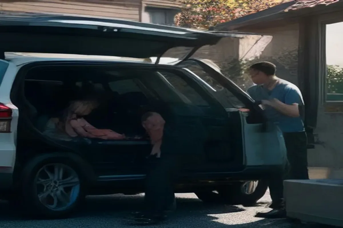 Family loading luggage into a car outside their home